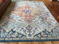 Close-up of multicolor distressed medallion pattern and rug condition