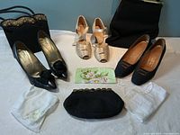 Full lot displayed with all bags, shoes, and handkerchiefs laid out on white cloth