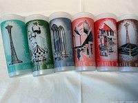 Six glasses front view showing colored illustrations of Seattle World's Fair attractions