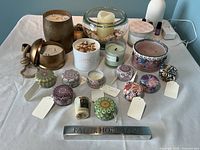 Full overview of all candles, diffuser and oils displayed on white tablecloth.