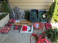 Wide view showing all items including artificial trees, greenery, mats, decorative leaf, glass bowl, ornaments, and candle holder.