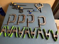 Photo showing all clamps laid out on a table for overview.