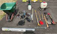 Full view of all gardening and irrigation items including wheelbarrow, tools, irrigation tubing, landscape cloth.