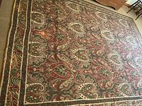 Full view of rug laid on carpeted floor showing overall pattern and size