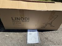 Closed original box for Linodi weight bench LI-3100 with assembly manual outside the box.