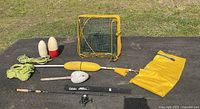 Full lot laid out on asphalt showing shrimp pot, buoys, fishing pole, dry bag.