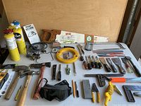 Overview of the tools including Bernzomatic torches, fuel canisters, saws, multiple hand tools, measuring tape, and safety goggles.