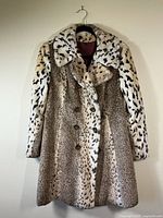 Faux fur animal print coat front view, showing double-breasted buttons and mixed print pattern