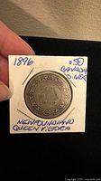 Front side of the 1896 Newfoundland Queen Victoria 50 cent silver coin showing the date and denomination with decorative border.