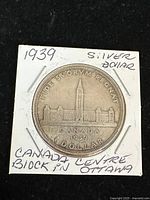 Reverse of 1939 Canadian silver dollar showing Canadian Parliament centre block with inscriptions.