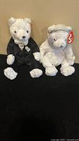 Front view of the Ty Beanie Groom and Bride Bears side by side on black background.