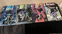 Four Batman comic books from 1990 laid out side by side on flat surface showing front covers