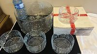 Full set of one large fruit serving bowl and four smaller matching bowls with box visible.