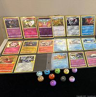 25 Pokémon cards arranged in protective sleeves showing various Pokémon characters, all in a single layer.
