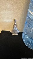 Small vintage Japanese sterling silver perfume bottle shown next to a water bottle for size reference