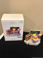 Ornament and original box showing front of box with Peanuts characters in classroom scene.
