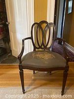 Front view of the Hepplewhite revival armchair showing dark wood frame and floral seat upholstery.