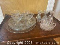 Photo showing two large crystal platters/cake stands, four crystal dessert stemware glasses, one small crystal pitcher, and one crystal bowl