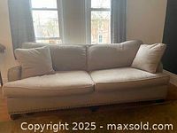 Front view of beige Benchmade sofa showing full length and cushions.