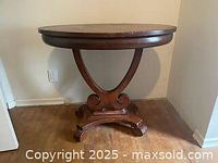 Front view of oval tabletop and pedestal base