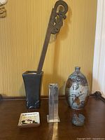 View of entire lot on wooden surface against yellow wall showing all six items grouped together.