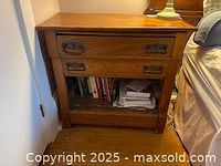 Full front view of the oak chest showing two drawers and open lower compartment with contents removed.
