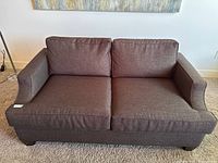 Front view of Van Gogh Designs loveseat sofa with two seat and two back cushions upholstered in dark brown fabric showing its overall good condition and minor wear
