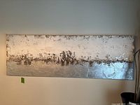 Full front view of the rectangular abstract art piece hanging on a wall.