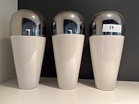 Front view showing three identical vases with silver top and white bottom arranged side by side.