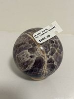 Front view of a polished amethyst chevron sphere 59.5 mm diameter with visible purple and white banding, labeled with price $400.