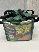 Green fabric carrying case showing label for Advanced Bocce Set Pétanque Avancé