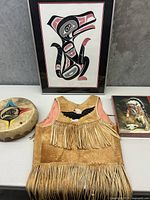 Overview of all four items: framed print, vest, drum, puzzle box