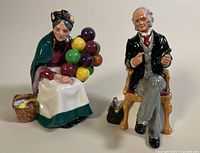 Both porcelain figurines displayed side by side showing a full view of each.