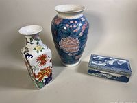 Overview of the three Asian porcelain pieces together on a plain background