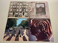 Four vintage classic rock LP album covers showing The Rolling Stones Physical Graffiti, Led Zeppelin IV, The Beatles Abbey Road, and The Rolling Stones Sticky Fingers