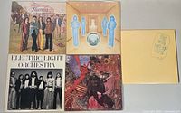 Five vinyl record albums laid flat showing front covers including The Guess Who, Journey, Electric Light Orchestra, Santana and The Who live album.