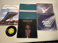 Six classic rock vinyl albums displayed in a group including Blood Sweat & Tears, Steppenwolf, Emerson Lake & Palmer, and others. All jackets and records are shown.