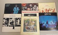 Six vinyl albums laid flat including David Bowie and Genesis titles to show lot contents and condition.