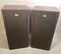Pair of SANSUI AA-3900 speakers front view with visible fabric grills and wood casings