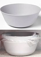 Single light grey plastic serving bowl with smooth finish on a white background, showing shape and size.