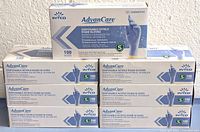 Front view of seven stacked boxes of AdvanCare disposable nitrile exam gloves, size small, 100 gloves per box.
