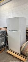 Front view of the complete white Frigidaire refrigerator showing its height and clean exterior.