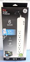 Box packaging showing GE Pro Surge Protector branding, features, and electrical specifications.