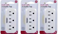 Three boxed GE Guide Light 3-Outlet Wall Taps in white, still sealed in packaging showing front label.