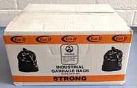 Closed cardboard box labeled Eco II Industrial Garbage Bags, strong, EcoLogo certified.