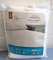 Sealed package of Mainstays double size waterproof mattress pad with product label visible