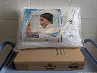 Mediflow Water Pillow in original sealed packaging on a blue cart.