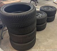 Stack of four Handkook Winter i cape evo2 tires 225/45 R18 V95, visible tread pattern and sidewall close-up.