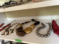 Overview of five necklaces on shelf, showing full lot