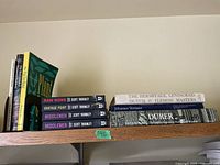 Shelf with coffee table books including plant books, Scott Thornley novels, and art books.